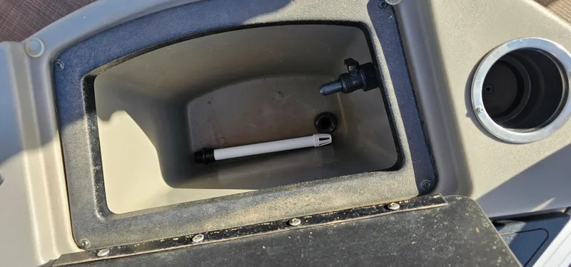 Slide: The Image of Storage compartment in 2024 Sun Tracker BB-18 boat, featuring a pen and cup holder. - 21