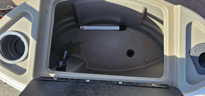 Slide: The Image of 2024 Sun Tracker BB-18 boat storage compartment with cup holder and drain plug. - 8