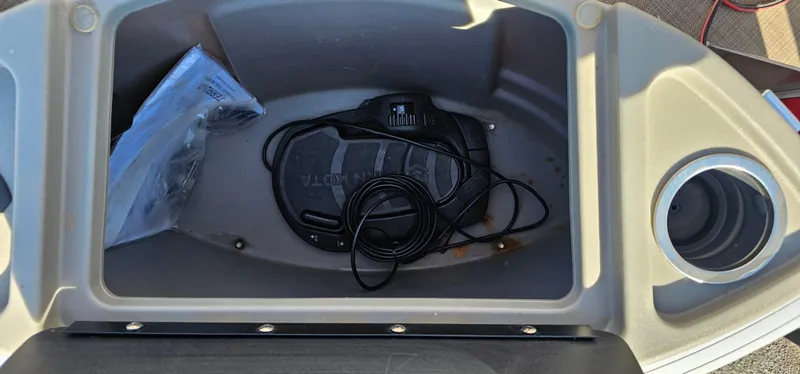 Slide: The Image of Storage compartment of 2024 Sun Tracker BB-18 boat with cables and cup holder. - 9