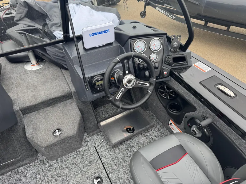 Slide: The Image of 2025 Tracker Targa V-18 Combo boat interior with steering wheel and control panel. - 12