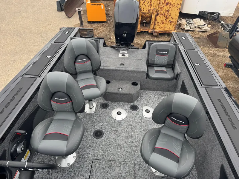 Slide: The Image of 2025 Tracker Targa V-18 Combo boat interior with four gray seats and carpeted flooring. - 8