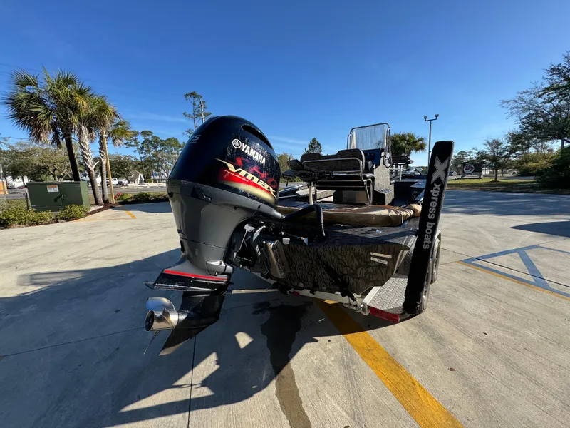 Slide: The Image of 2023 Xpress H22B boat with Yamaha engine, parked outdoors on a sunny day. - 14