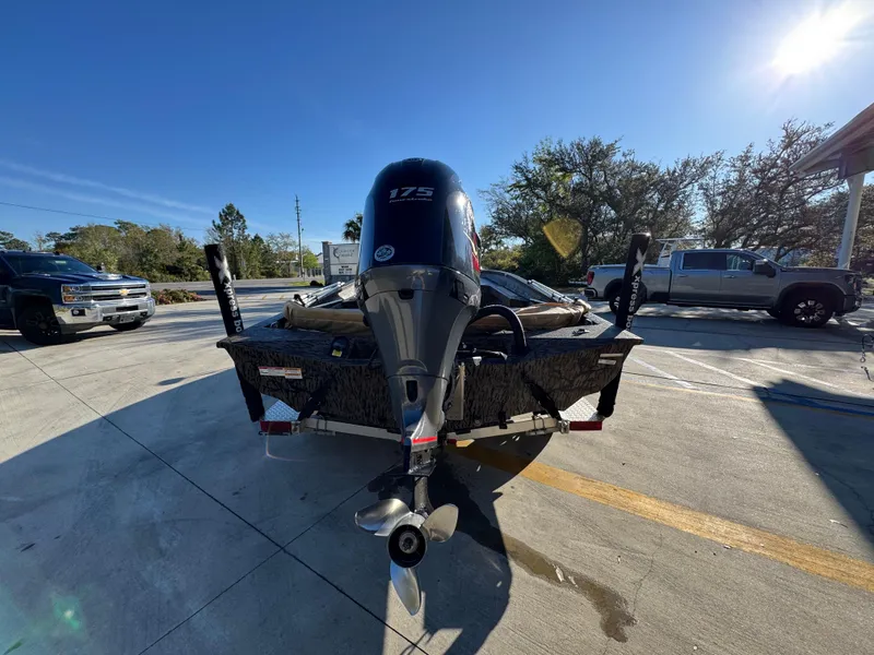Slide: The Image of 2023 Xpress H22B boat with 175 HP engine, parked outdoors on a sunny day. - 15