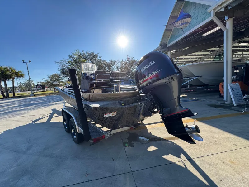 Slide: The Image of 2023 Xpress H22B boat with Yamaha motor on trailer, parked outdoors under clear sky. - 16