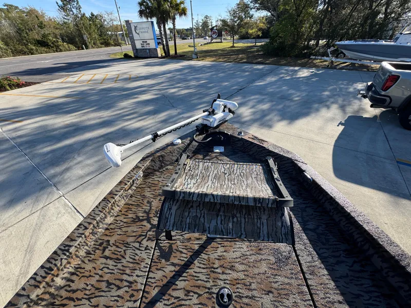 Slide: The Image of 2023 Xpress H22B boat with camouflage design, parked outdoors on a sunny day. - 19