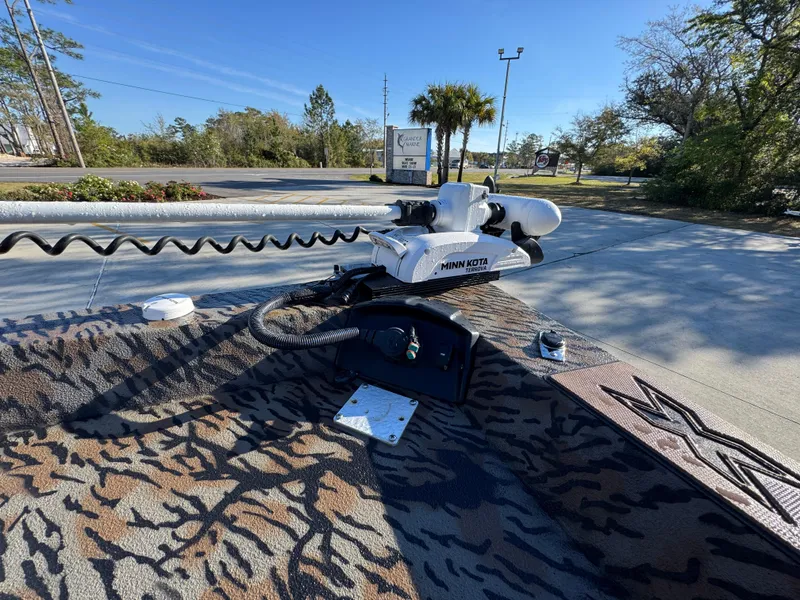 Slide: The Image of 2023 Xpress H22B boat with Minn Kota trolling motor on patterned deck. - 20