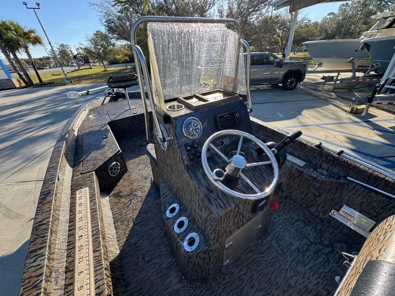 Slide: The Image of 2023 Xpress H22B boat with camouflage design, featuring a central steering console. - 29