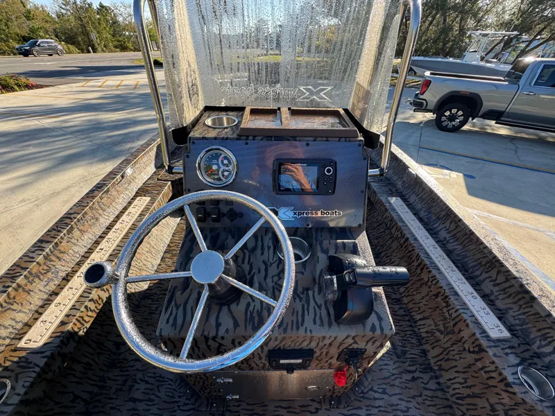 Slide: The Image of 2023 Xpress H22B boat dashboard with steering wheel and control panel. - 30