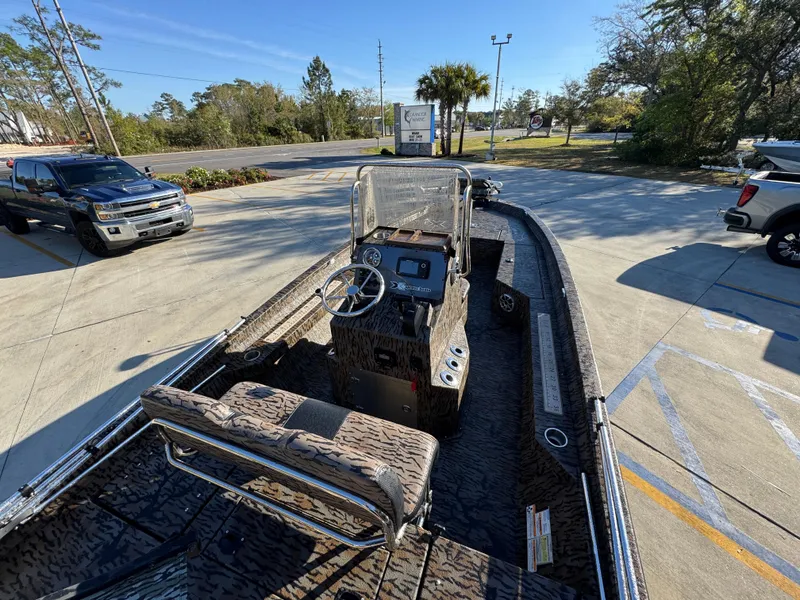 Slide: The Image of 2023 Xpress H22B boat with camouflage interior, parked in a sunny outdoor lot. - 34