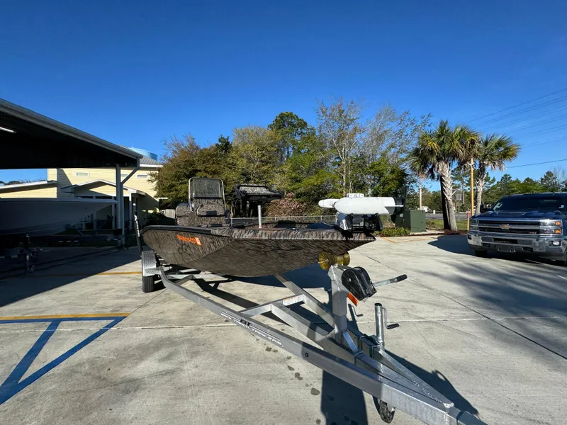 Slide: The Image of 2023 Xpress H22B boat on trailer in sunny outdoor setting. - 7