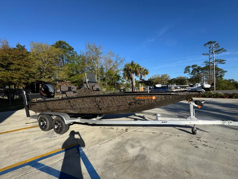 Slide: The Image of 2023 Xpress H22B boat on trailer in sunny outdoor setting. - 9