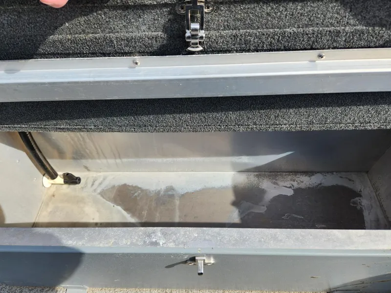 Slide: The Image of Open storage compartment in 2021 Starcraft 16 SF DLX boat, showing interior details. - 12