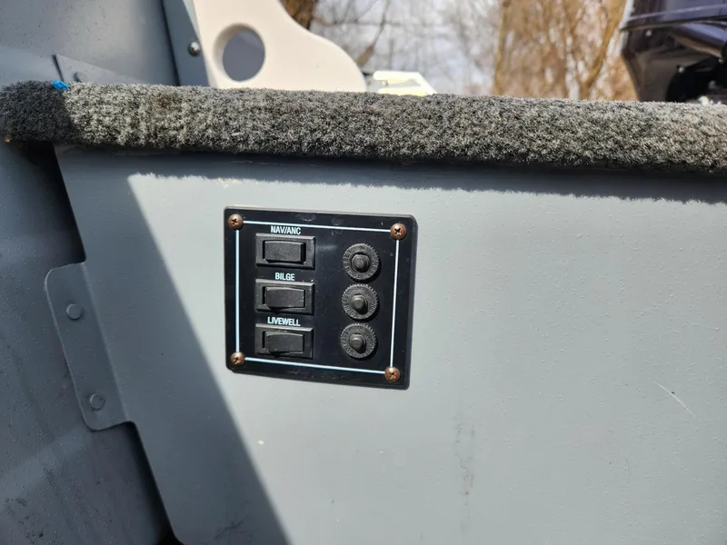 Slide: The Image of Control panel on a 2021 Starcraft 16 SF DLX boat with switches for various functions. - 14
