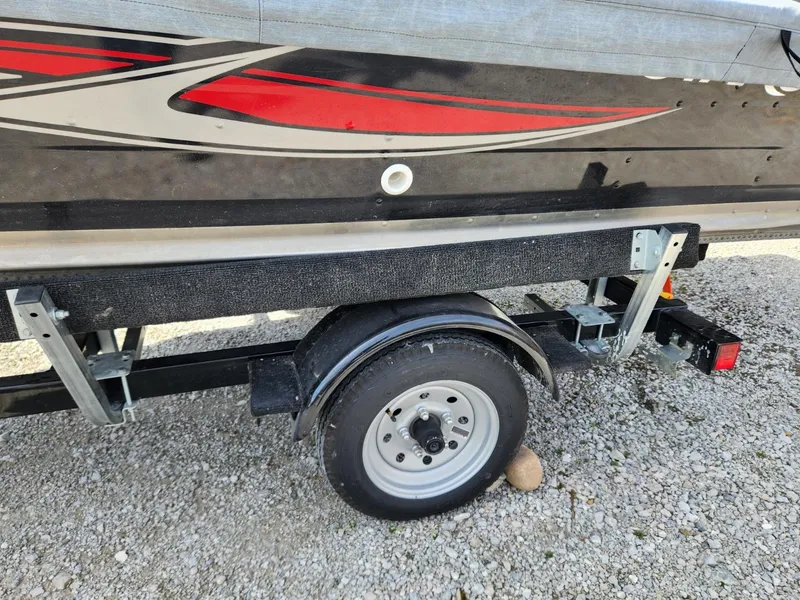 Slide: The Image of Trailer of 2021 Starcraft 16 SF DLX boat on gravel surface. - 15