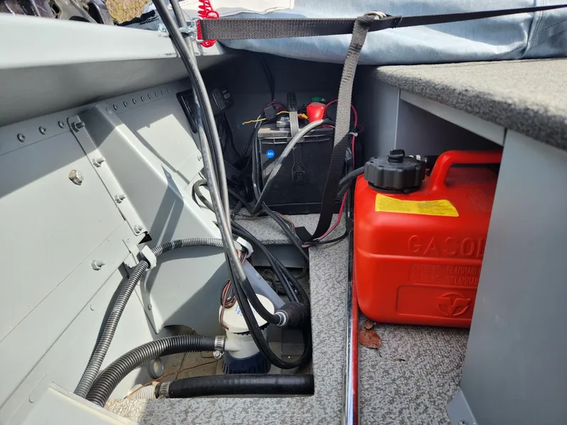 Slide: The Image of Interior of a 2021 Starcraft 16 SF DLX boat showing battery and gas can. - 4