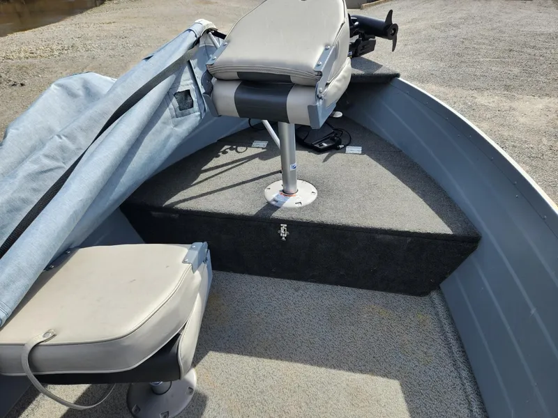 Slide: The Image of 2021 Starcraft 16 SF DLX boat interior with seating and covered equipment. - 8