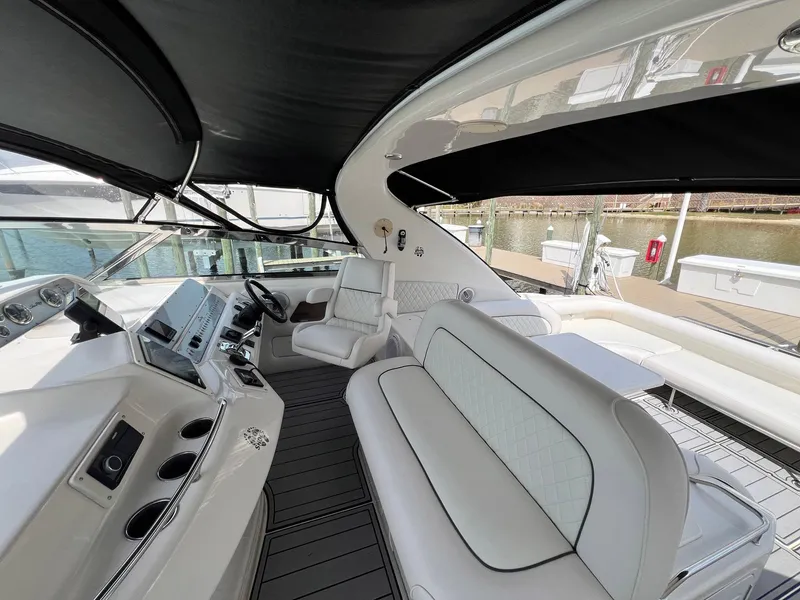 Slide: The Image of 1997 Sea Ray 450 Sundancer yacht interior with luxurious seating and helm. - 11