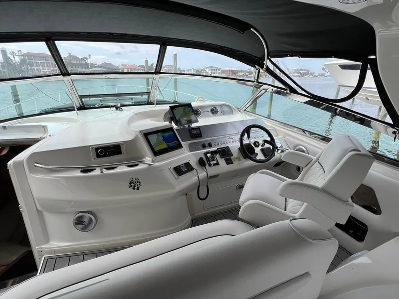 Slide: The Image of 1997 Sea Ray 450 Sundancer helm with modern controls and panoramic ocean view. - 13
