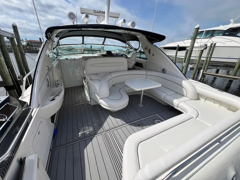Slide: The Image of 1997 Sea Ray 450 Sundancer yacht with spacious seating and sleek design at a marina. - 14