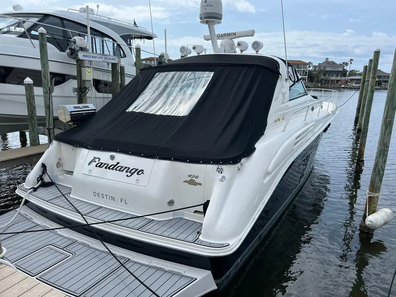 Slide: The Image of 1997 Sea Ray 450 Sundancer docked, rear view with black cover, Destin, FL. - 18