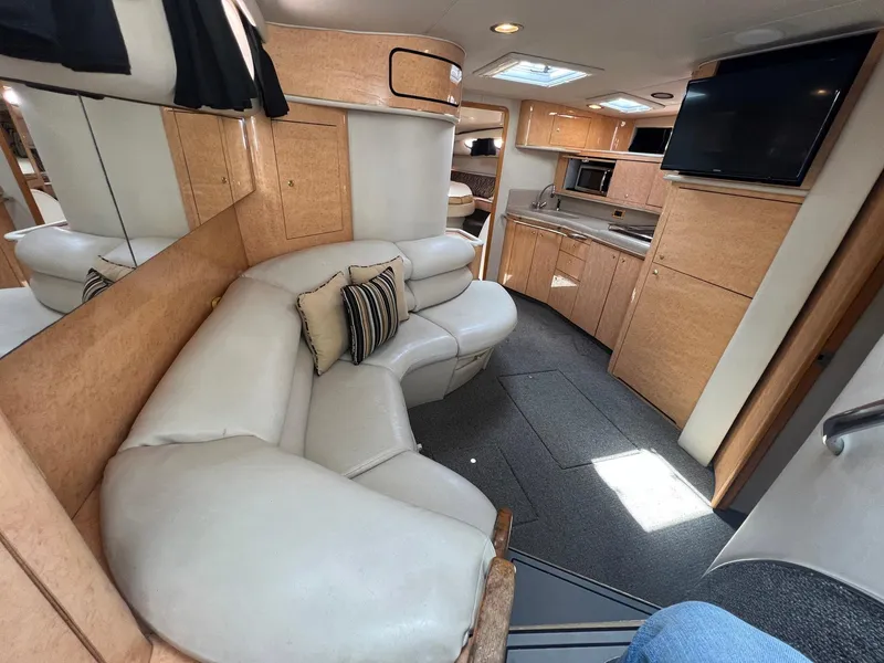 Slide: The Image of Interior of 1997 Sea Ray 450 Sundancer yacht with leather seating and modern amenities. - 4