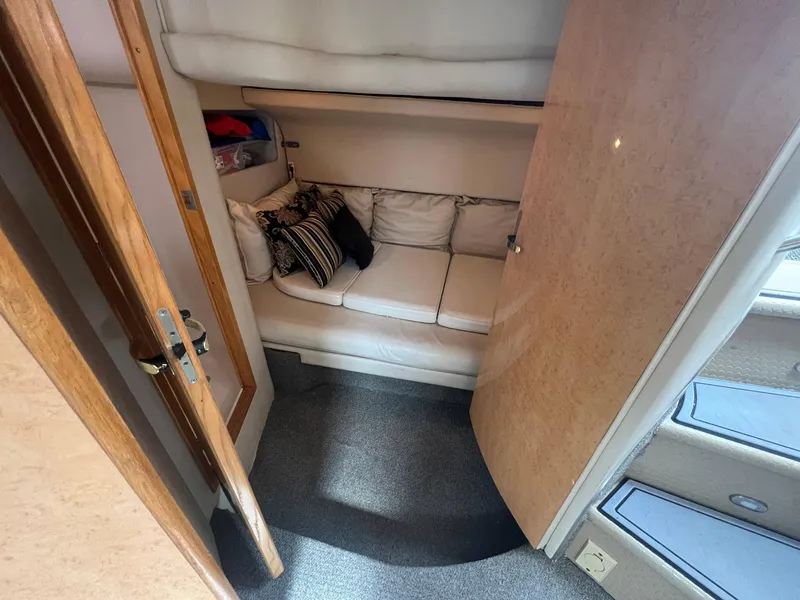 Slide: The Image of Interior cabin of 1997 Sea Ray 450 Sundancer with cozy seating and cushions. - 8