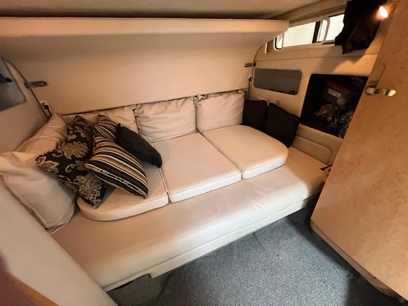 Slide: The Image of Interior cabin of 1997 Sea Ray 450 Sundancer with cushioned seating and decorative pillows. - 9