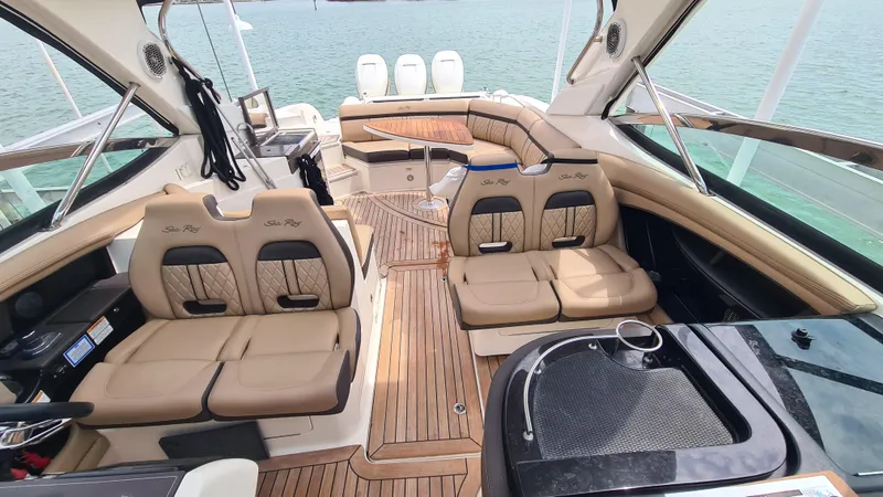 Slide: The Image of Luxurious 2017 Sea Ray SLX 350 OB boat interior with tan leather seating and wood flooring. - 10