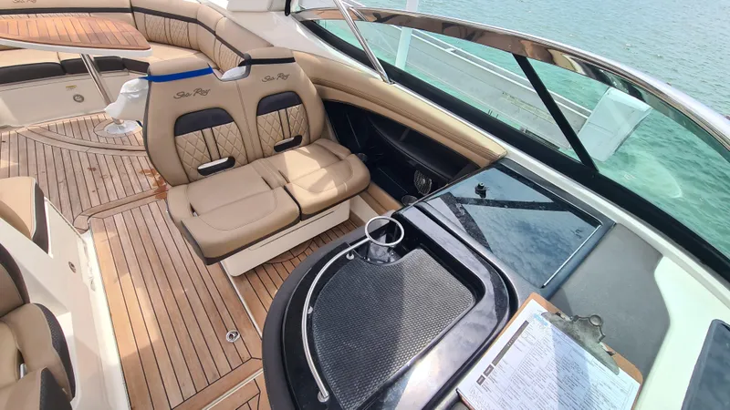 Slide: The Image of 2017 Sea Ray SLX 350 OB boat interior with tan seating and wooden deck. - 11
