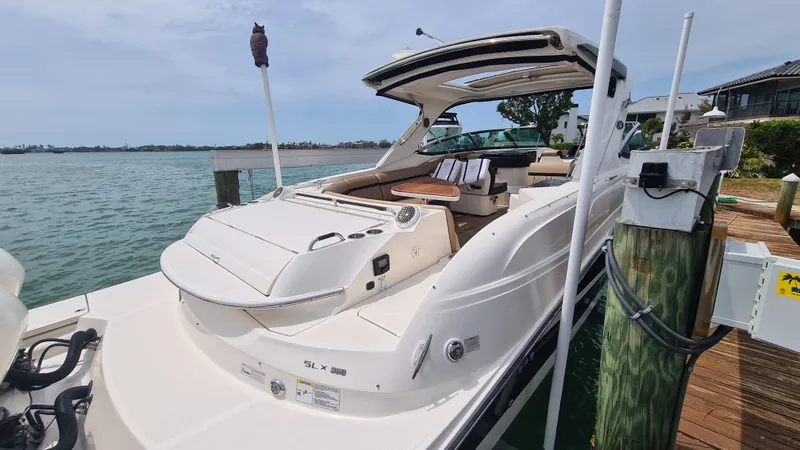 Slide: The Image of 2017 Sea Ray SLX 350 OB boat docked by the water on a sunny day. - 14