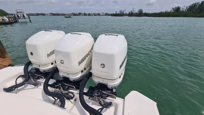 Slide: The Image of 2017 Sea Ray SLX 350 OB with triple Mercury outboard engines on a calm lake. - 17