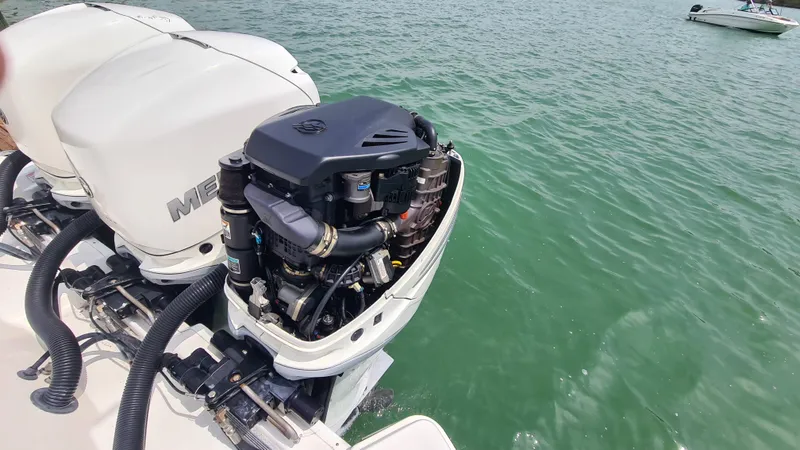 Slide: The Image of 2017 Sea Ray SLX 350 OB with open outboard engine on water. - 18