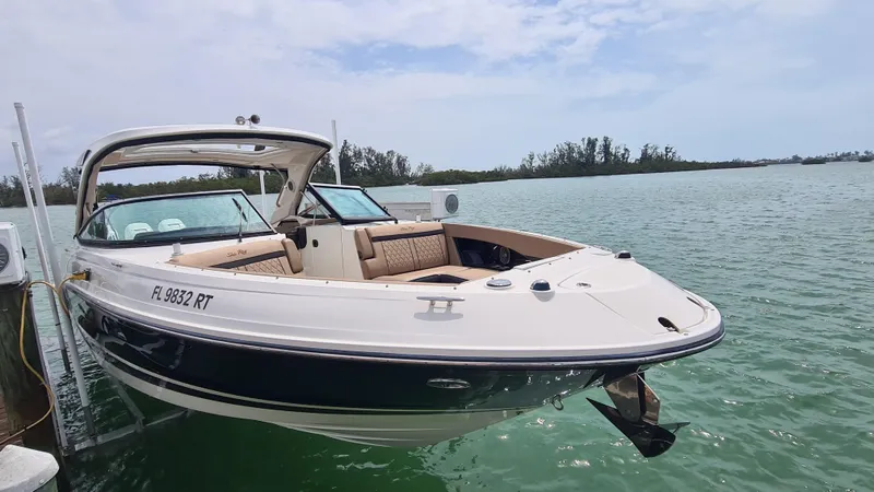 Slide: The Image of 2017 Sea Ray SLX 350 OB boat docked on calm water. - 2