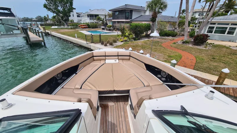 Slide: The Image of 2017 Sea Ray SLX 350 OB boat with spacious bow seating, docked near waterfront homes. - 5