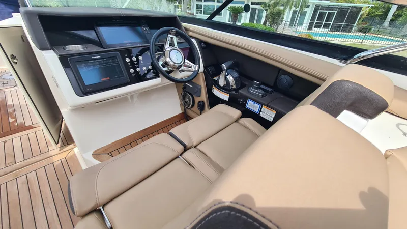 Slide: The Image of 2017 Sea Ray SLX 350 OB boat cockpit with leather seating and modern controls. - 9