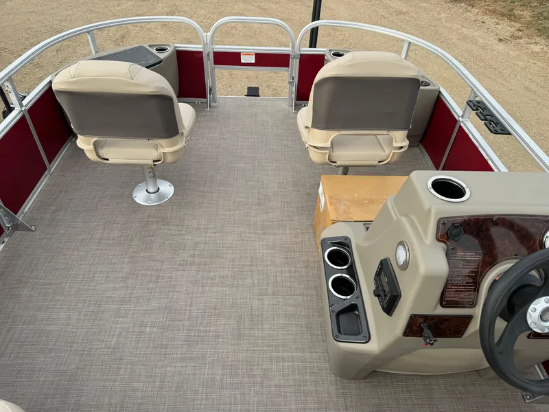 Slide: The Image of 2024 Sun Tracker Bass Buggy 18 DLX pontoon boat interior with seating and steering console. - 4
