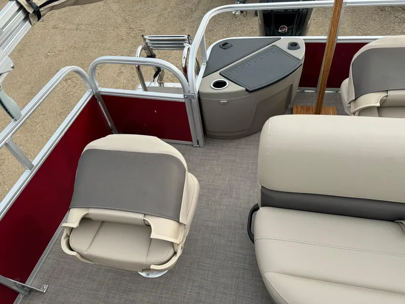 Slide: The Image of 2024 Sun Tracker Bass Buggy 18 DLX interior with beige seating and red paneling. - 5