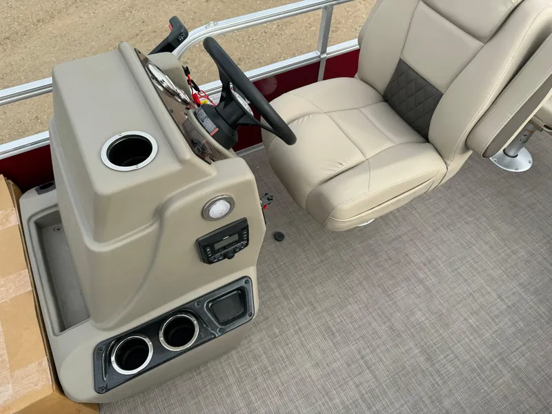 Slide: The Image of 2024 Sun Tracker Bass Buggy 18 DLX interior with beige captain's chair and control console. - 9