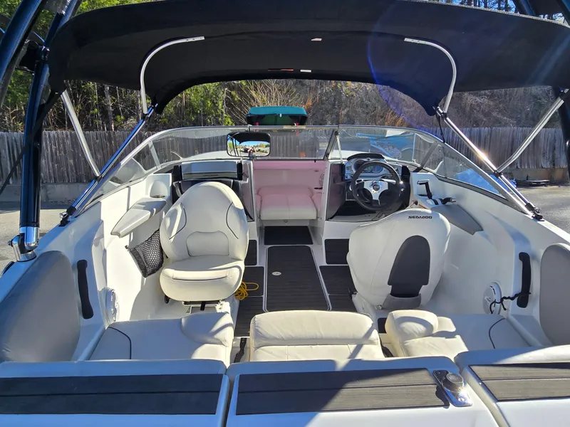 Slide: The Image of 2012 Sea-Doo Challenger 180 interior with seating and steering wheel, under a canopy. - 10
