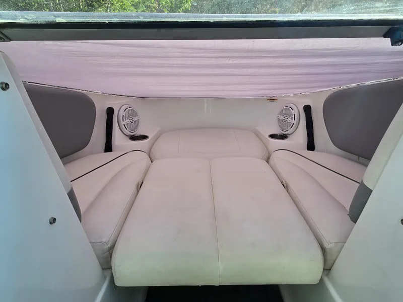 Slide: The Image of Interior view of 2012 Sea-Doo Challenger 180 boat with white seating and speakers. - 11