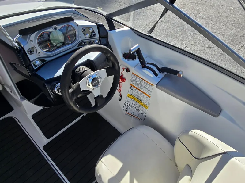 Slide: The Image of 2012 Sea-Doo Challenger 180 cockpit with steering wheel and control panel. - 12