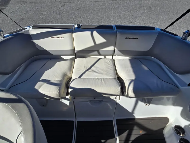 Slide: The Image of 2012 Sea-Doo Challenger 180 boat interior with white cushioned seating. - 13