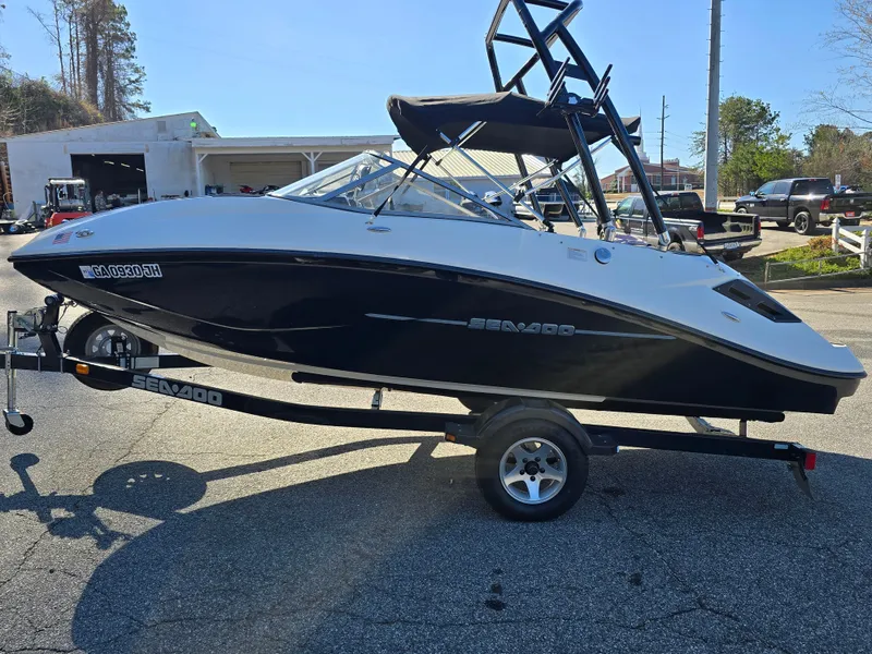 Slide: The Image of 2012 Sea-Doo Challenger 180 boat on trailer, parked outdoors. - 2