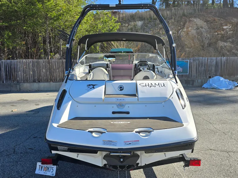 Slide: The Image of 2012 Sea-Doo Challenger 180 boat parked, rear view, with "Shamu" name visible. - 4