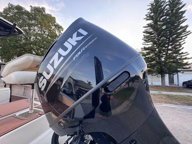 Slide: The Image of 2021 Carolina Skiff Ultra Elite 24 with Suzuki outboard motor, parked outdoors. - 18