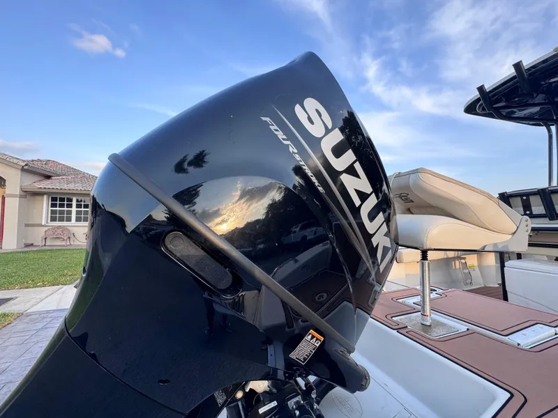 Slide: The Image of Suzuki outboard motor on 2021 Carolina Skiff Ultra Elite 24 boat, sunny day. - 19