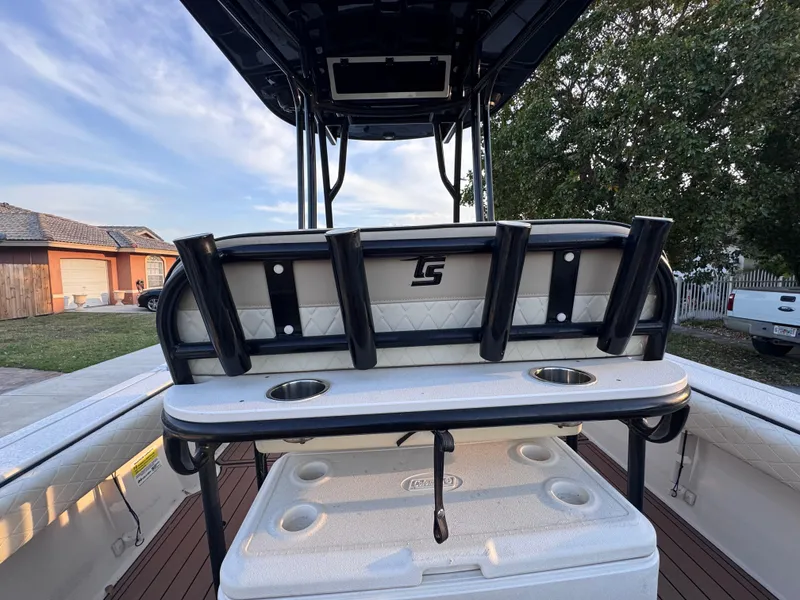 Slide: The Image of 2021 Carolina Skiff Ultra Elite 24 boat interior with rod holders and cooler. - 25