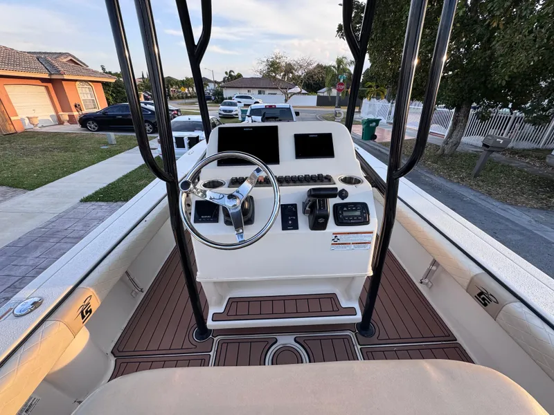 Slide: The Image of 2021 Carolina Skiff Ultra Elite 24 boat console with steering wheel and controls. - 26