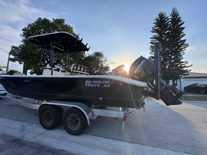 Slide: The Image of 2021 Carolina Skiff Ultra Elite 24 boat on trailer at sunset. - 3