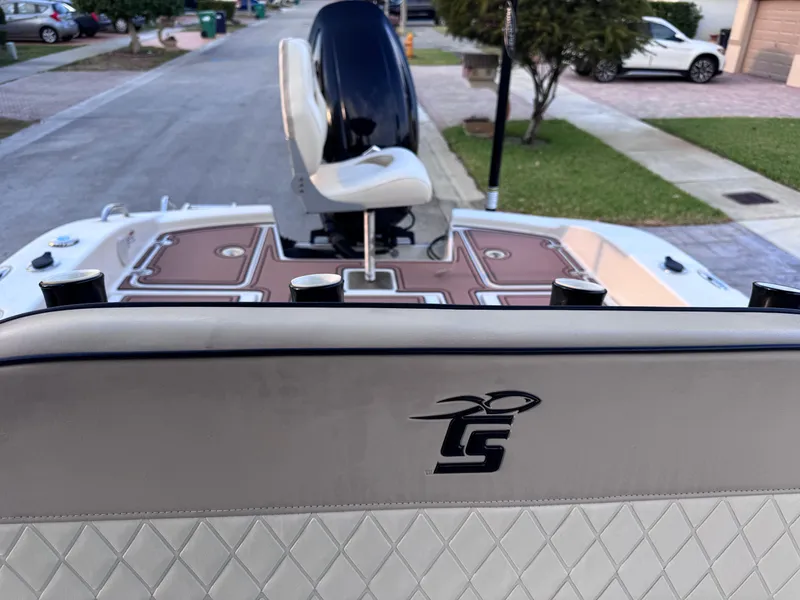 Slide: The Image of 2021 Carolina Skiff Ultra Elite 24 boat interior with seating and motor, parked on a street. - 30
